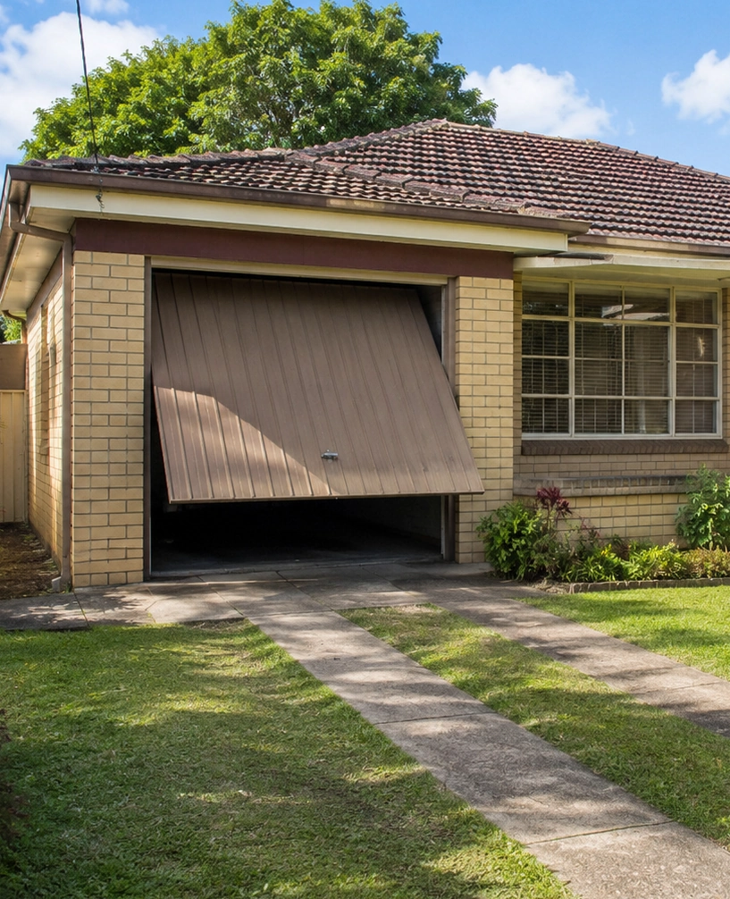 Brisbane Roller Doors technician repairing a garage door